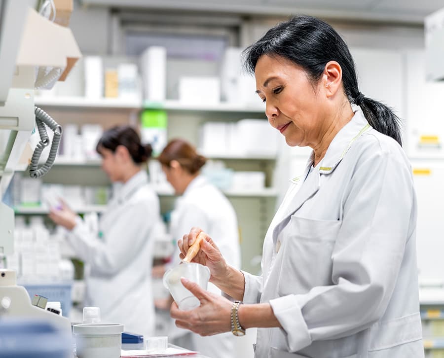 A pharmacist in a health system pharmacy prepares a prescription.